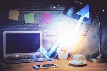 Computer on desktop with point up arrows hologram. Double exposure. Concept of success.