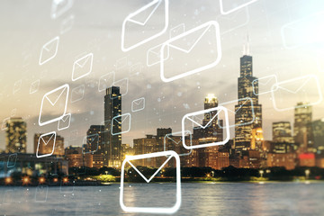 Double exposure of abstract virtual postal envelopes hologram on Chicago city skyscrapers...