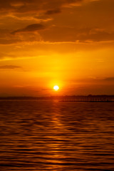 Sunset sky at the lake with clouds.