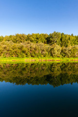 Siberian River Ob surrounded by Trees in Early morning in Russia in sunny weather during summer

