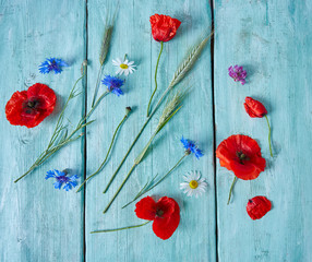 cornflowers on turquoise surface on wooden surface