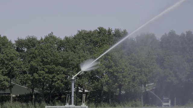 Big agriculture water gun in a field on a sunny and hot summer day 2