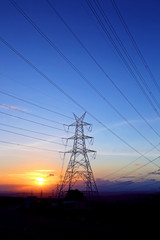 high-voltage power lines at sunset,high voltage electric transmission tower