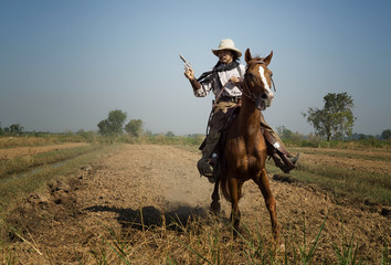 cowboy riding horses in the desert