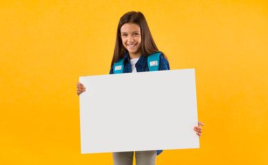 Excited girl holding white paper for promo
