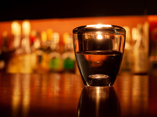 Candle Light in Glass on Bar Counter at Night