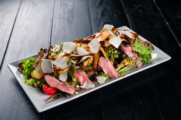 pieces of fillet of duck with salad a dish for the company