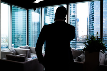 Respectable businessman making phone call in contemporary office