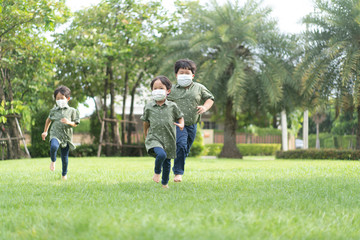Fototapeta premium 3 brothers are running and playing in the garden.