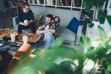 Friends having pizza party at home
