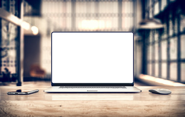 Laptop with frameless blank screen mockup template on table in industrial office loft interior -...