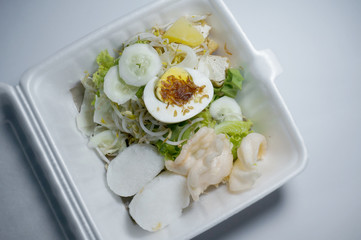 Gado-gado (Indonesian) is traditional indonesian food. rice cake, egg and vegetable with peanut sauce. Selective Focus.     