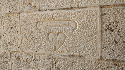 A sign on the wall in Perast, Montenegro