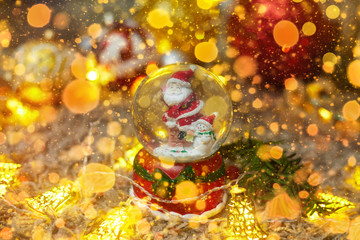 Fototapeta na wymiar postcard ,christmas ball with snow and santa claus and toys, bokeh, flatley, copyspace