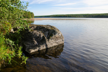 Kola landscape. A boulder on the bank of Medvezhye Plyoso lake (Umba river). Kola Peninsula,...