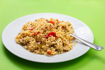 fresh vegetable salad with couscous on the plate