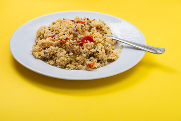 fresh vegetable salad with couscous on white plate