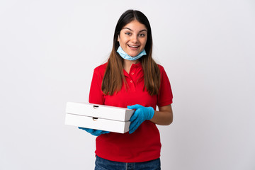 Pizza delivery woman holding a pizza isolated on white background with surprise and shocked facial expression
