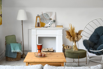 Stylish interior of living room with table and fireplace