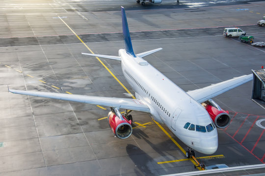 Aerial view on comercial airplane undocking in terminal the parking lot of the airport apron, services maintenance, refilling fuel after airspace.