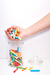 Small roll wish papers and a jar on white background. Wish jar. Wish concept. Dream, desire, wish, intention. The woman draws an intention from the jar.