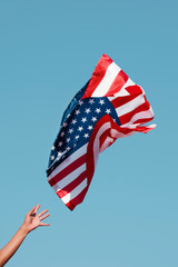 man launching an American flag to the sky