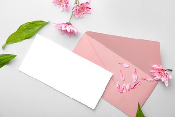 Composition with blank card and envelope on light background