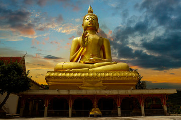 statue of buddha, in buddhist temple ,with golden color at sunset time