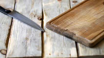 Selective focus. Defocus. Wooden cutting board and knife.