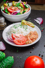 rice with zucchini and beans, salad, vegetarians, microgreen on the table vertical orientation