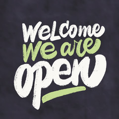 Welcome, we are open. Chalkboard sign.