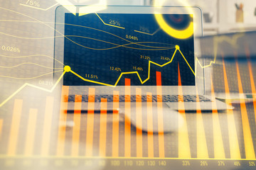 Financial market graph hologram and personal computer on background. Multi exposure. Concept of...