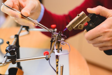 Closeup of male optician's hands repairing eyeglasses