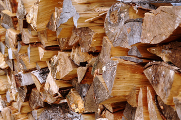 Abstract photograph of piles of natural wooden logs. Background. Harvesting firewood for the winter. Texture. Wood for the fireplace. Birch boards. Macrosymka. Copy space.