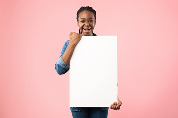 Joyful Black Girl Holding Empty White Board Posing In Studio