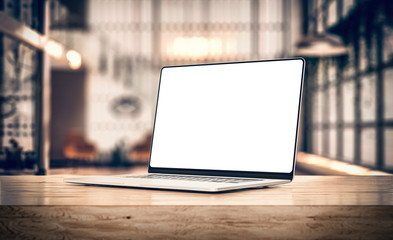 Laptop with frameless blank screen mockup template, rotated position on table in industrial office...