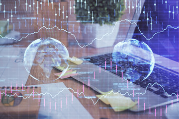 Double exposure of graph and financial info and work space with computer background. Concept of...