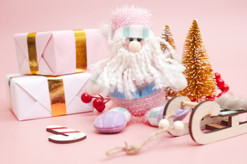Christmas composition, gifts on pastel pink background, copy space