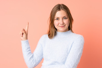 Teenager Ukrainian girl isolated on pink background showing and lifting a finger in sign of the best