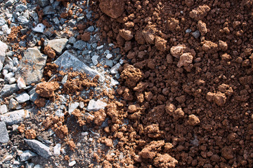 Red clay and grey stones texture and background.