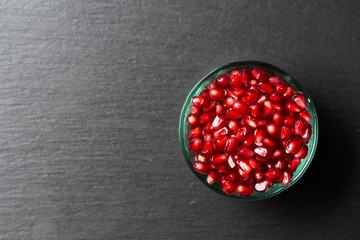 Peeled pomegranate in Minsk on a dark background.