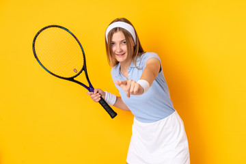 Teenager Ukrainian girl tennis player isolated on yellow background playing tennis