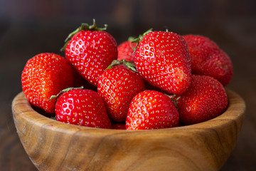 Ripe red strawberries on wooden table