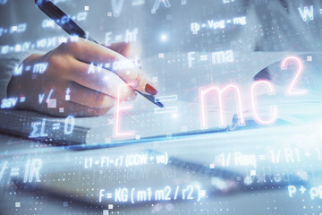 Science formula hologram over woman's hands taking notes background. Concept of study. Multi...