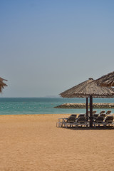 Recliners facing water on sunny day
