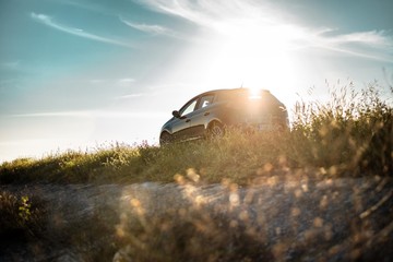 car on hill with sunshine light