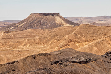View of the Ramon crater colorful mountains with traces of geological events. Negev desert. Israel
