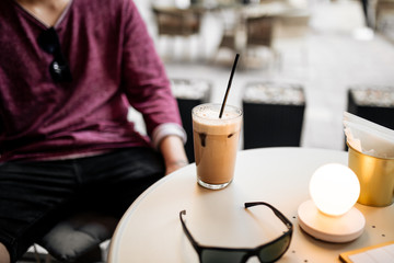 Man drinking latte coffee sitting in cafe