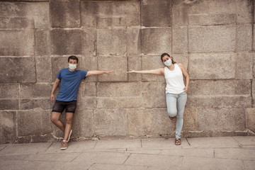 Obraz na płótnie Canvas Man and woman keeping social distancing. Coronavirus COVID-19 protection and New Normal