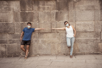 Man and woman keeping social distancing. Coronavirus COVID-19 protection and New Normal